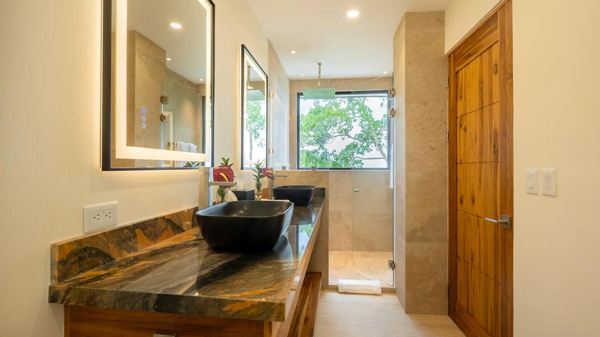 Master bathroom at Casa Rambutan with double black sinks and glass walk in shower