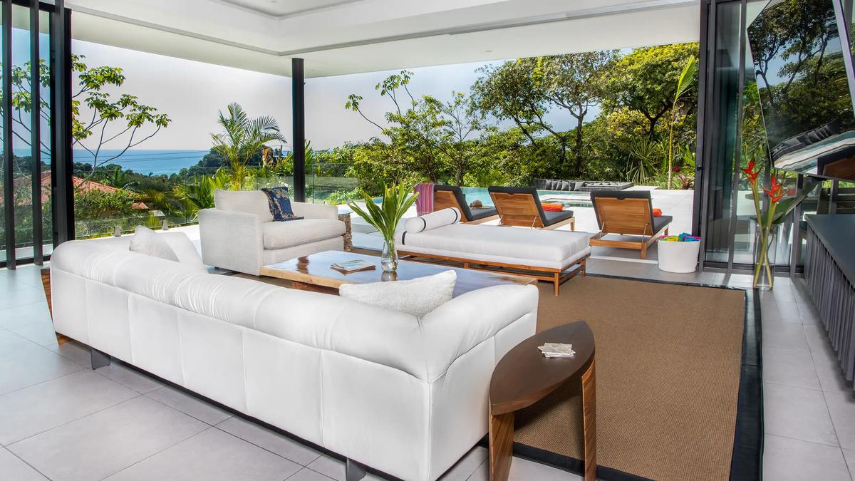 White leather sofa and daybed at Casa Nueva Vida opening to the pool and ocean