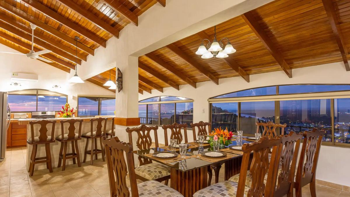 Dining room and curved breakfast bar at Casa Moreno at dusk