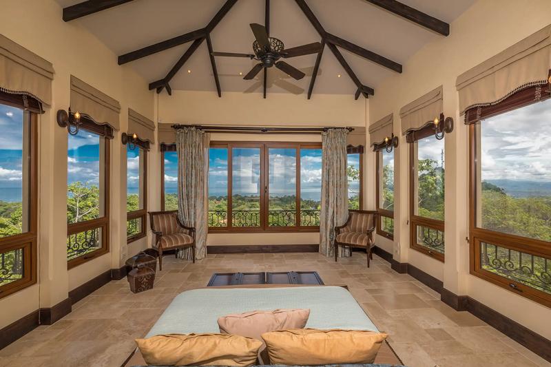Wraparound windows with ocean views in a Villa Marbella sitting room