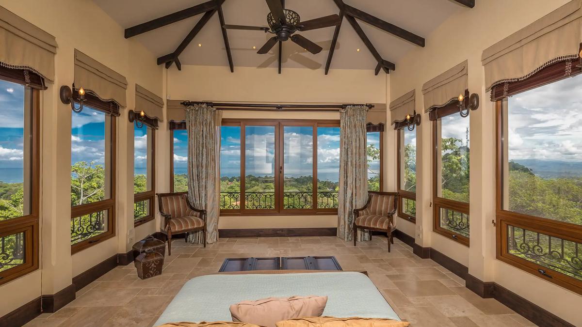 Wraparound windows with ocean views in a Villa Marbella sitting room