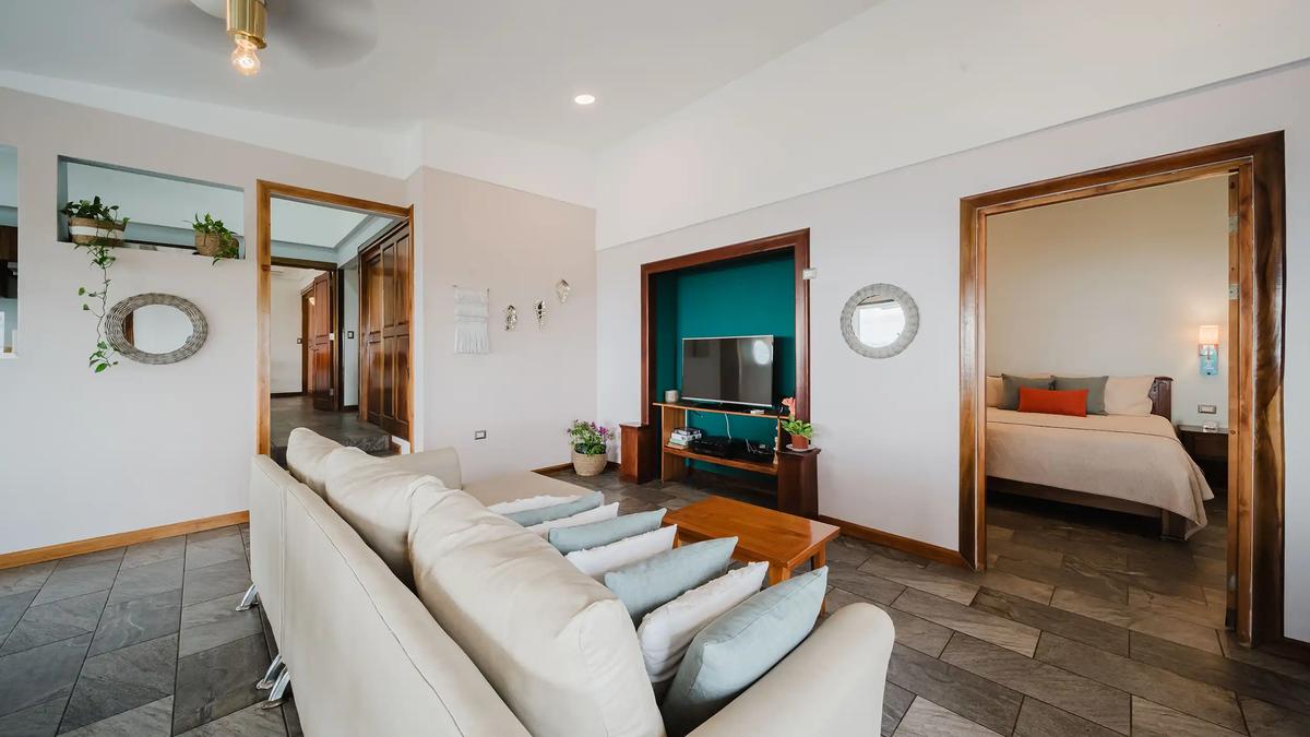 Living room at Casa Grande Vista with cream sectional and teal TV nook