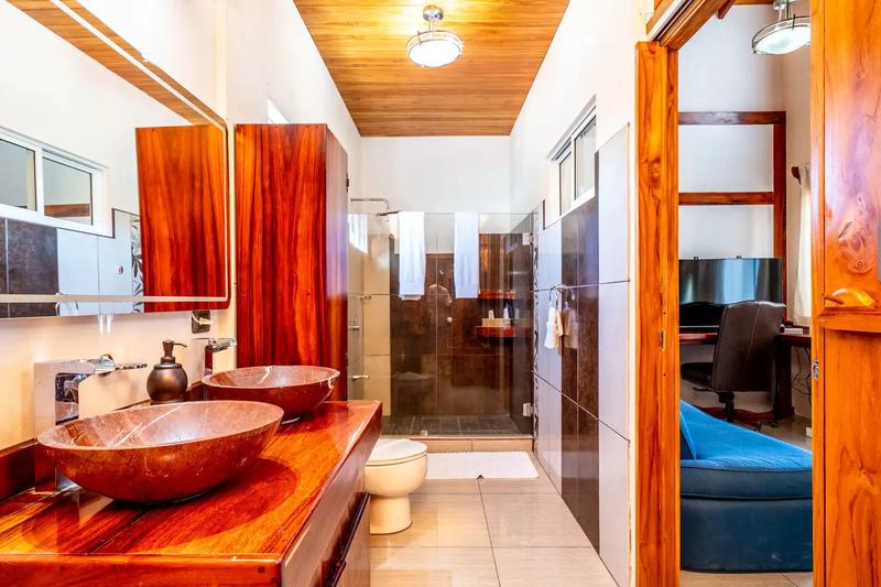 Master bathroom with twin stone vessel sinks and glass shower at Casa Alta Vista