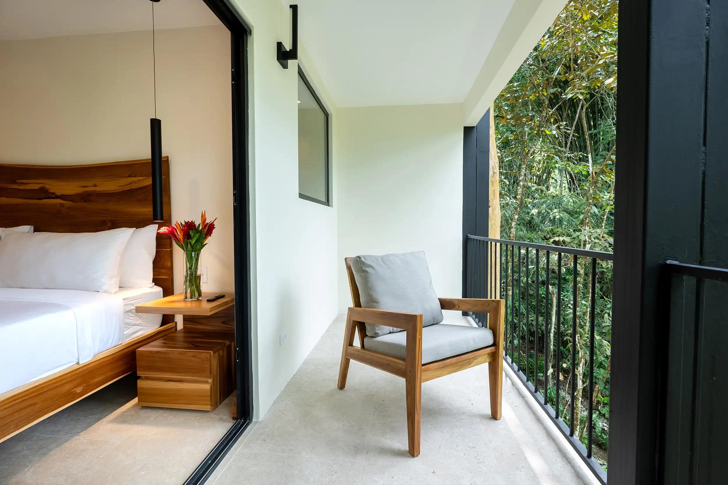 Private balcony chair overlooking the rainforest outside a Casa Dos Cascadas bedroom