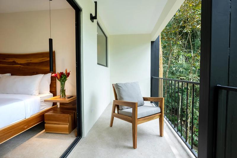Private balcony chair overlooking the rainforest outside a Casa Dos Cascadas bedroom