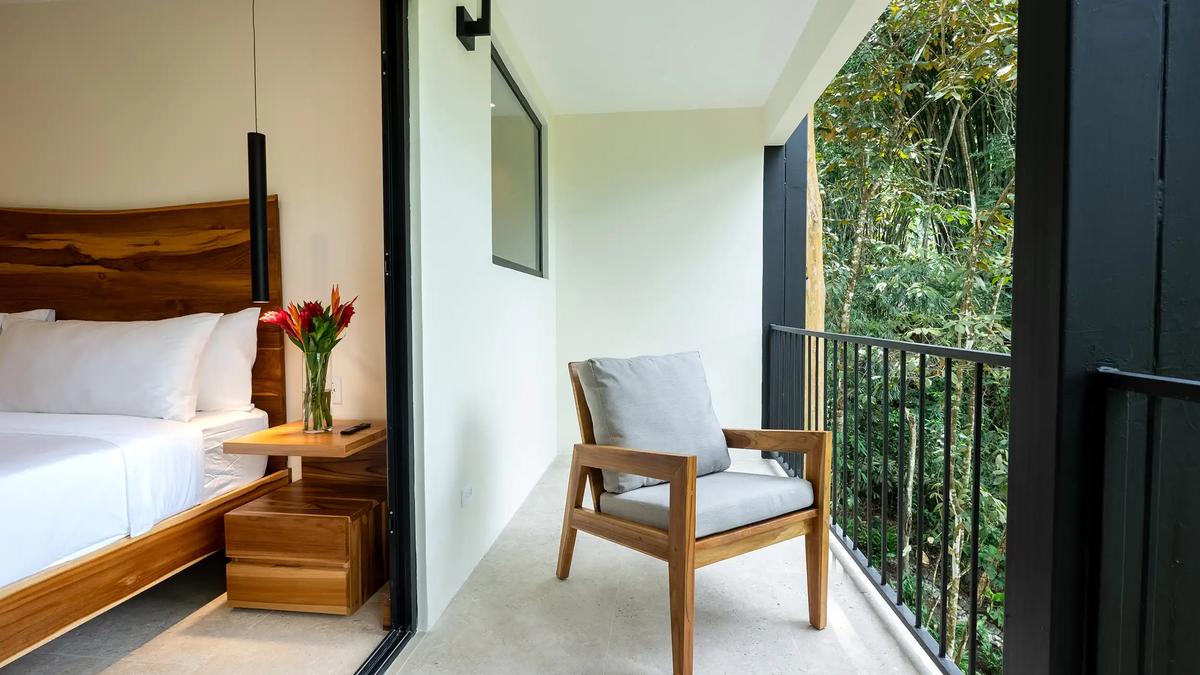 Private balcony chair overlooking the rainforest outside a Casa Dos Cascadas bedroom