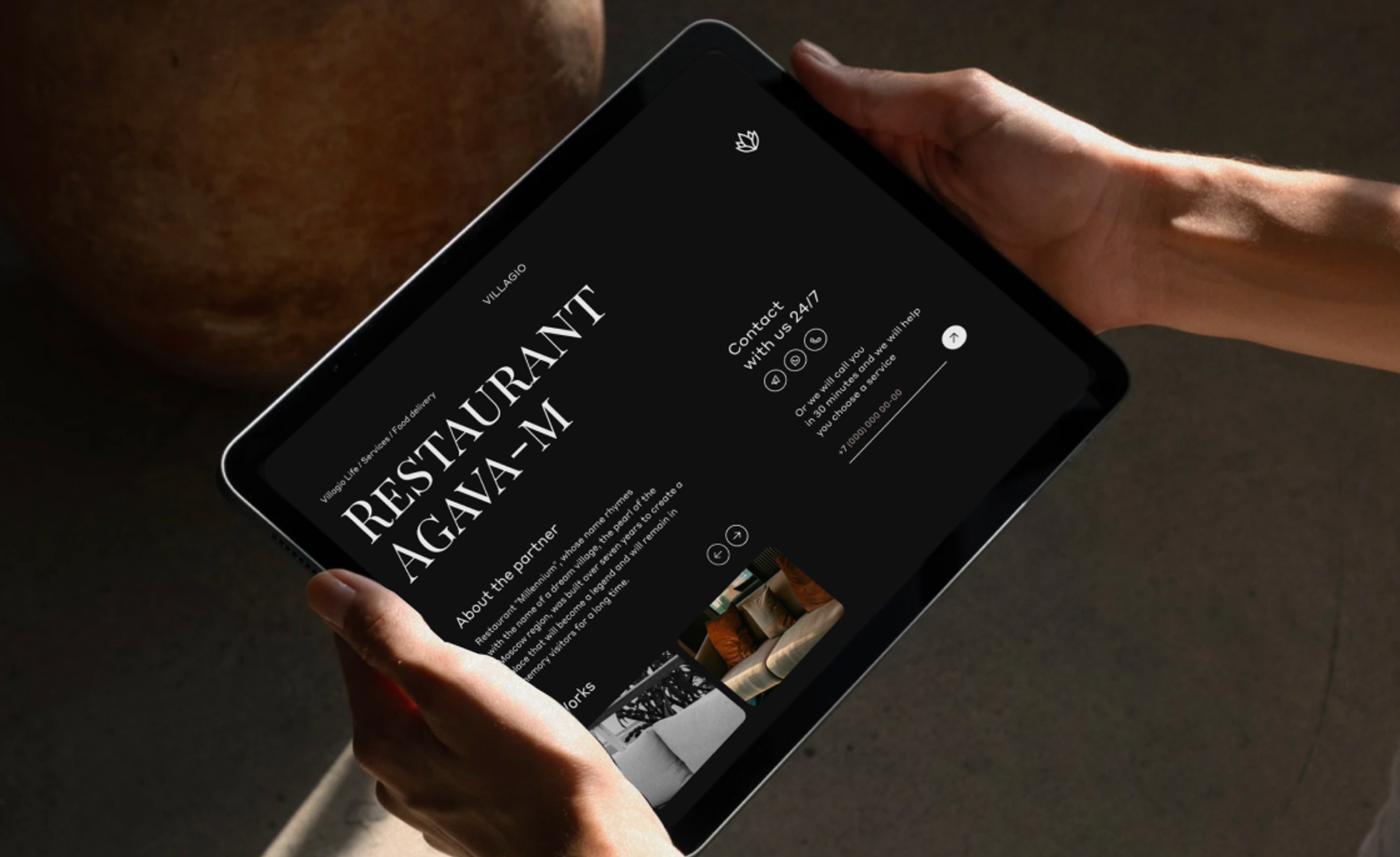 Hands holding a tablet showing the Restaurant Agava-M partner page