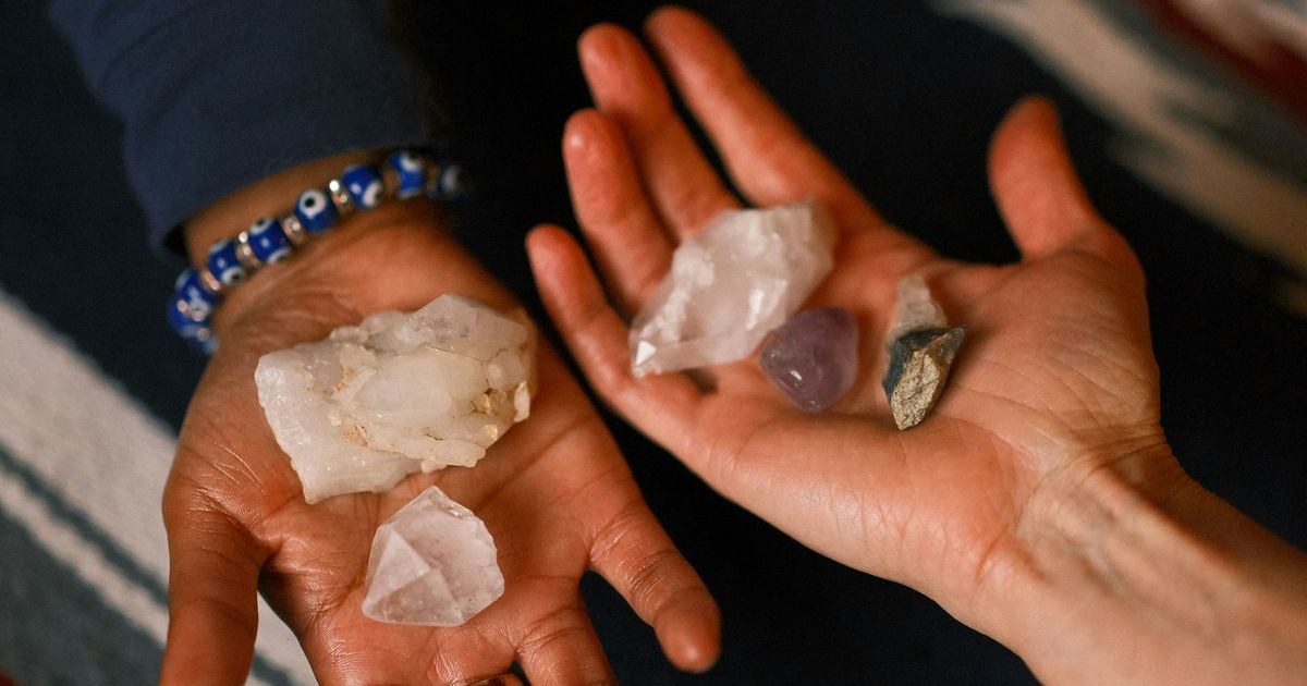 Hands offering a handful of mixed crystals