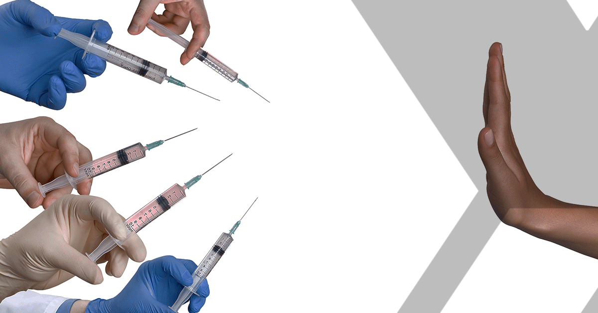 hand blocking several vaccine needles