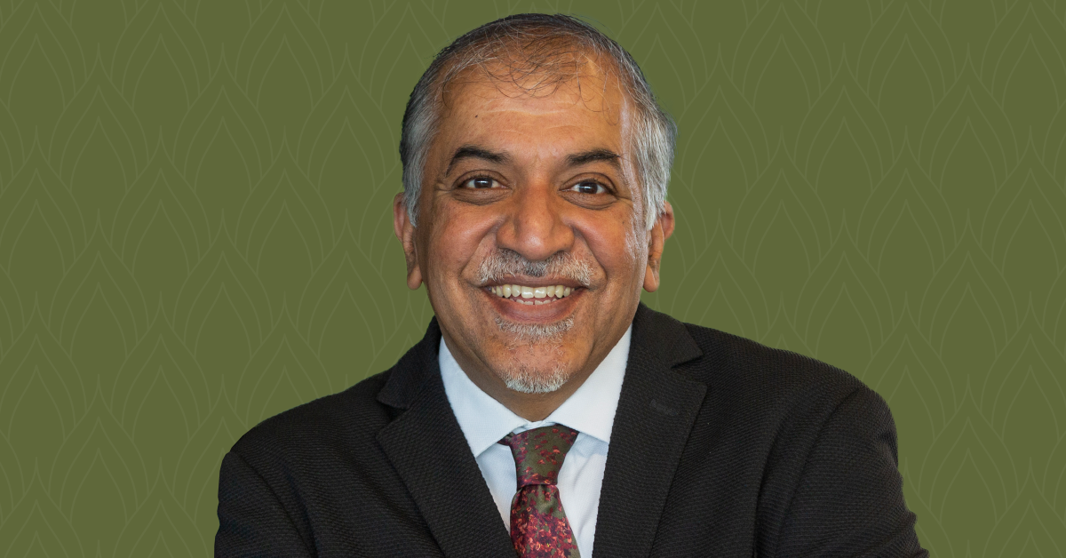 A headshot of Dr. Abhay Pandit, set against a dark green background.