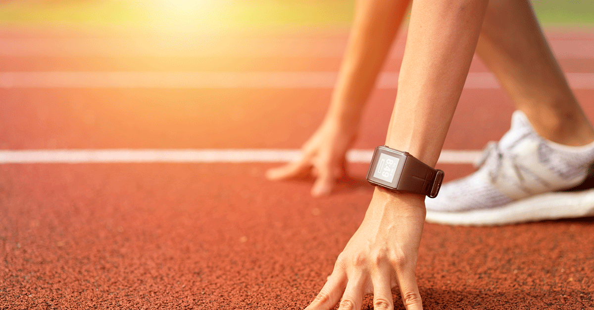 Runner at the start of a race with wearable device on wrist