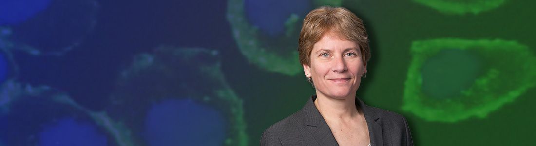 Carolyn Bertozzi Headshot on top of blue and green background