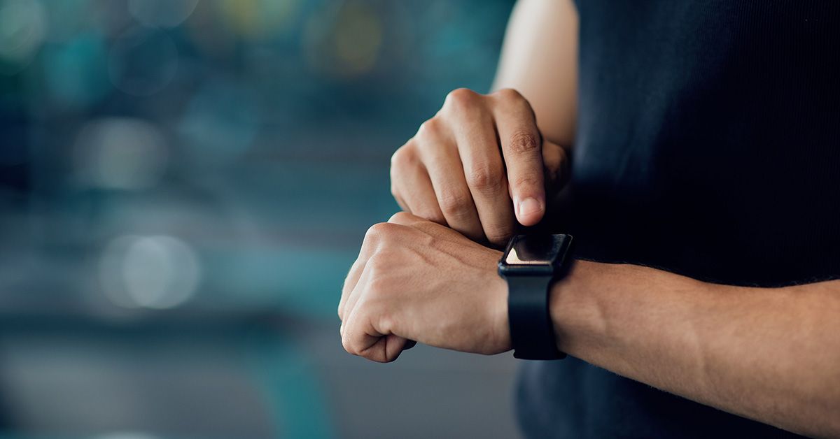 A person checking their smartwatch on their left wrist