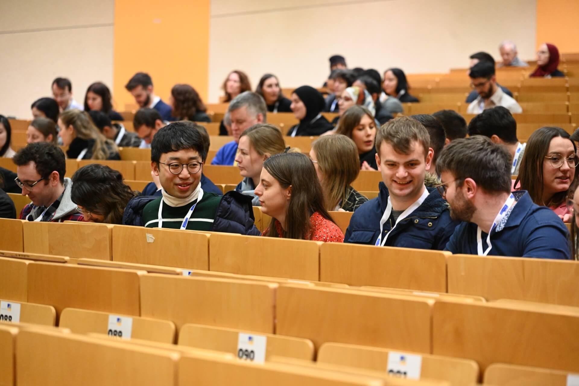 Attendees attending a session at the Bonn Symposium