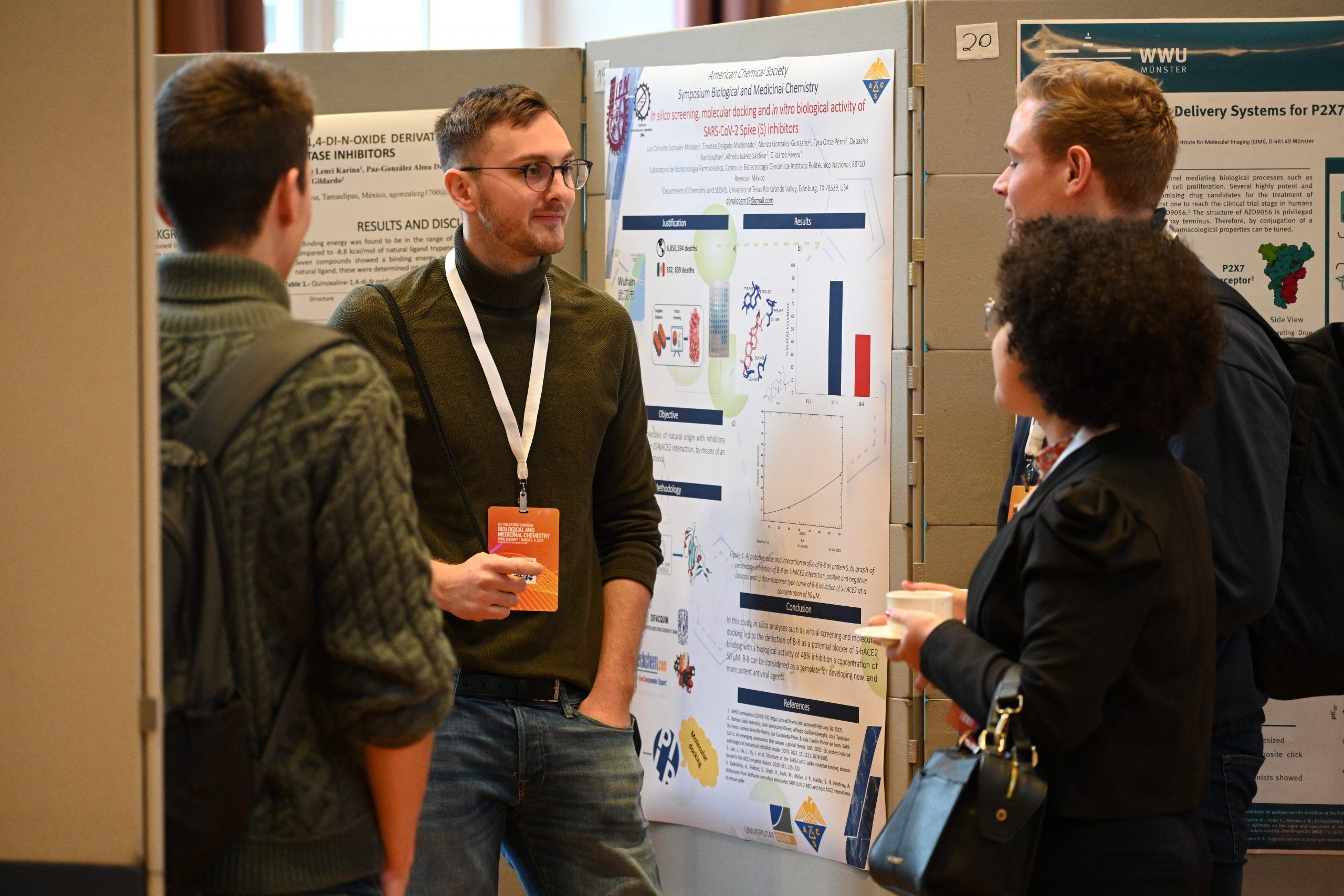 Attendees networking amidst posters at the Bonn Symposium