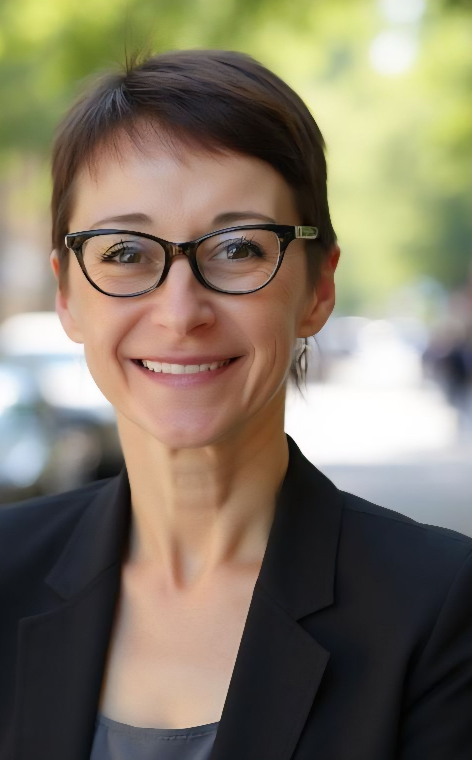 Portrait of Linda Anegawa, CMO, smiling in an office setting