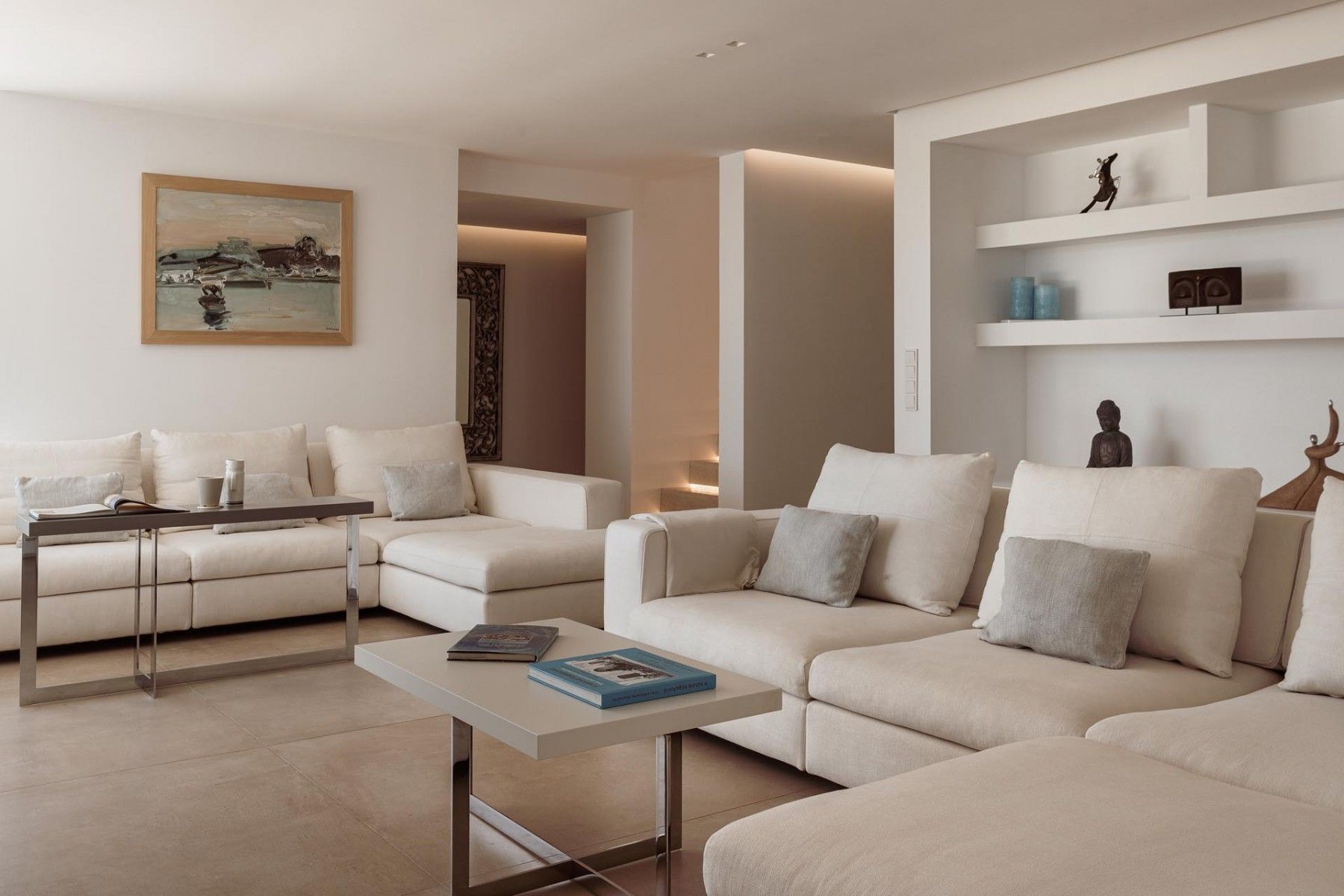 Elegant white sofas in the spacious living room of SeaClusion Luxury Villa, featuring modern decor and a serene ambiance.