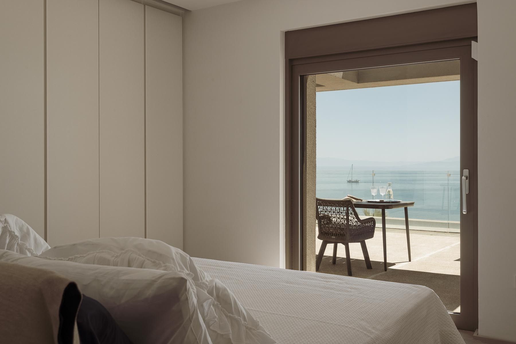 Sunlit bedroom with two single beds and neutral, modern decor.