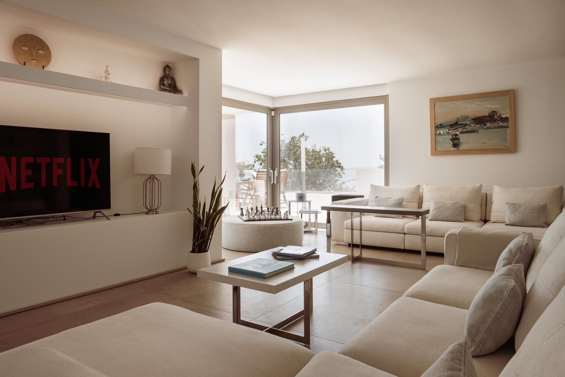 Stylish open-plan living room with neutral tones and contemporary furnishings.