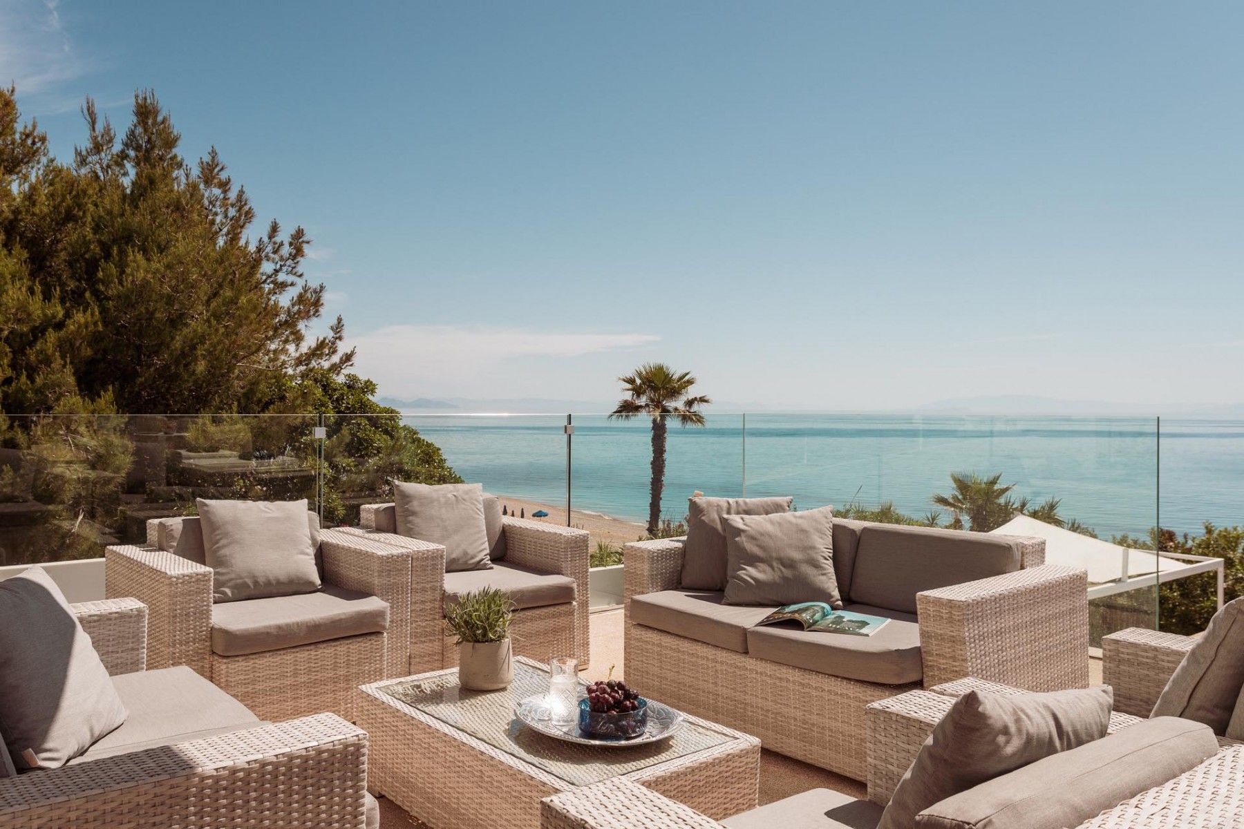 Elegant outdoor seating area with modern furniture overlooking the infinity pool.