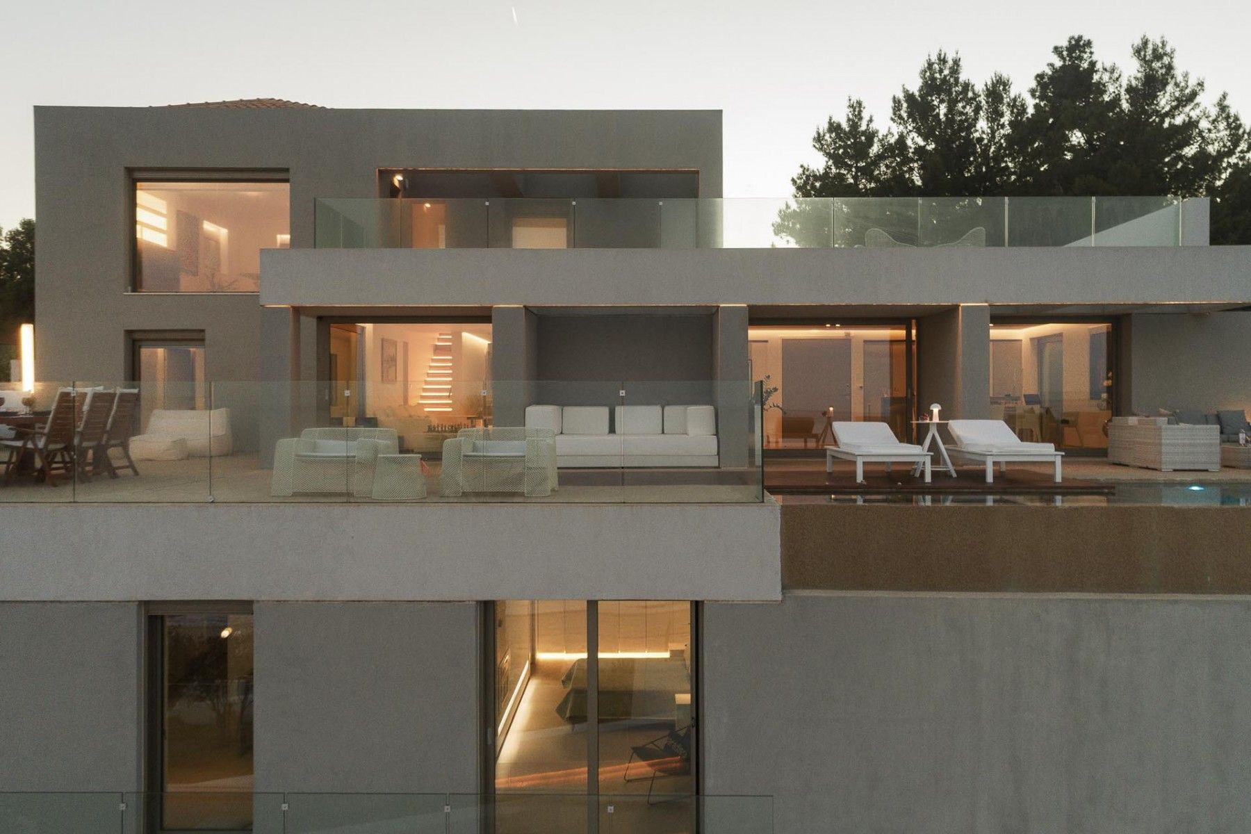 Sunset reflections in the infinity pool with the villa’s ambient lights.