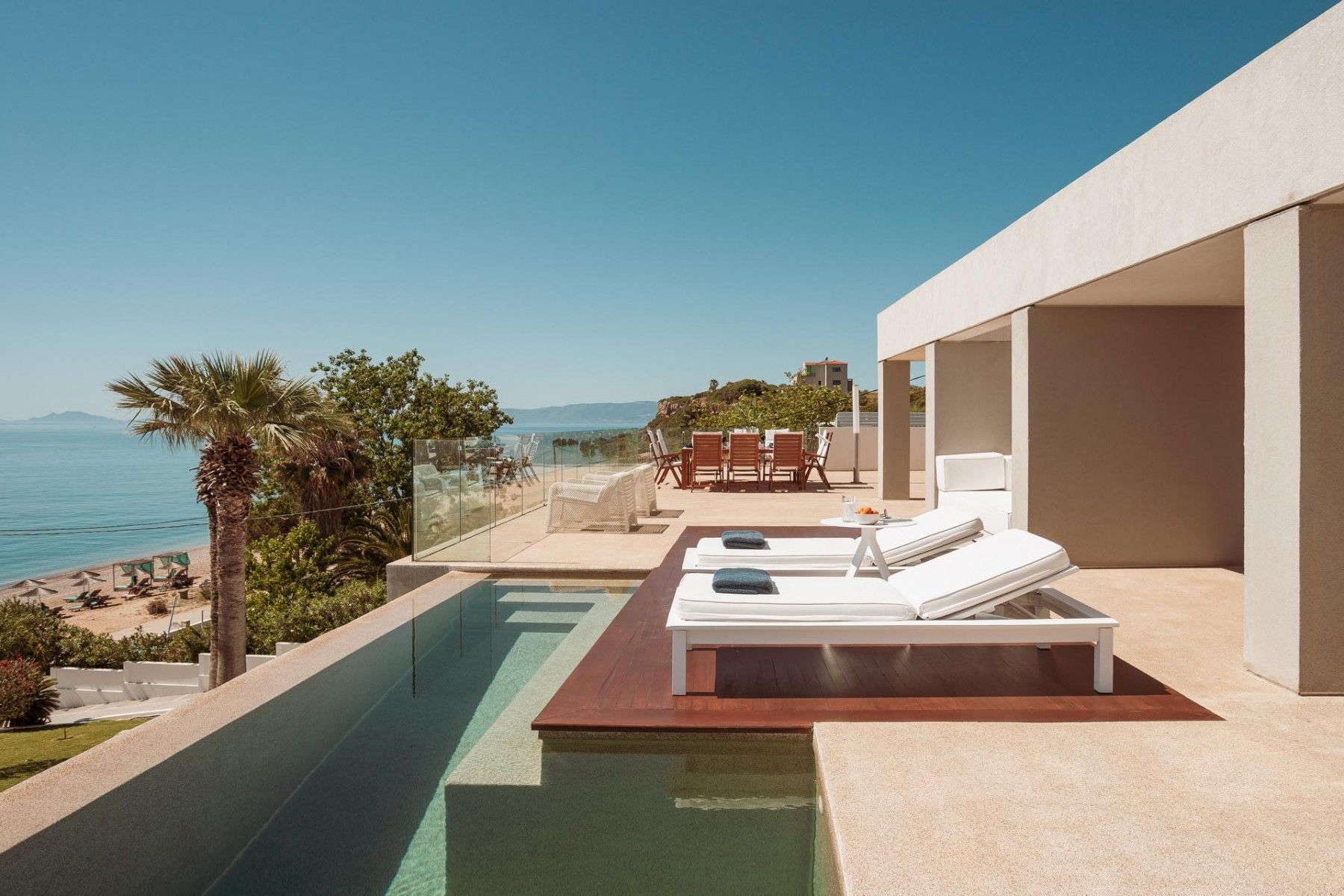 A sunny morning view of the poolside area at SeaClusion Luxury Villa.