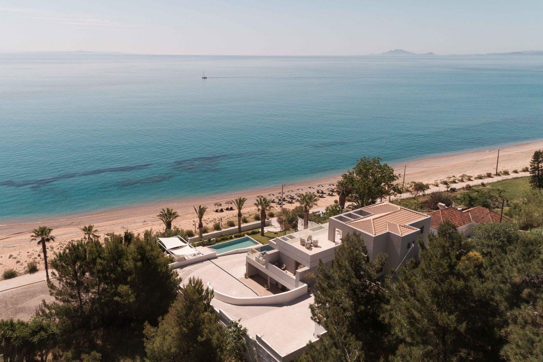 Crystal-clear pool reflecting the morning sun, surrounded by contemporary architecture.