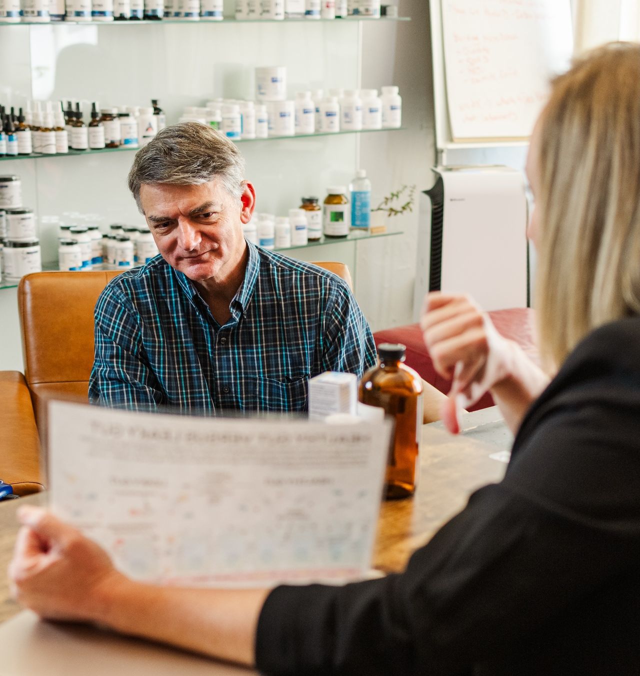 Patient learning elements of autoimmune treatment plan from Foundations Wellness practitioner