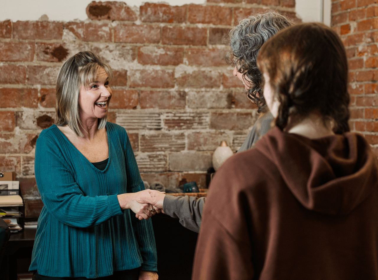 A Foundations Wellness team member shaking hands with a patient.