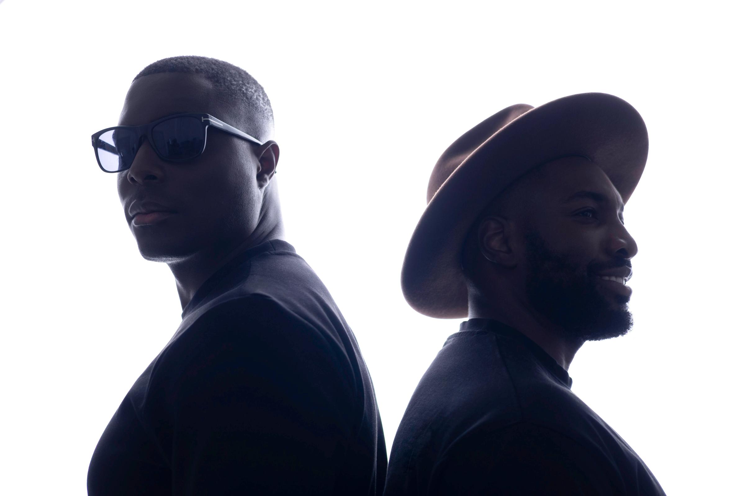 Elfried Samba and Michael Heaven, co-founders of Butterfly Effect, standing back to back