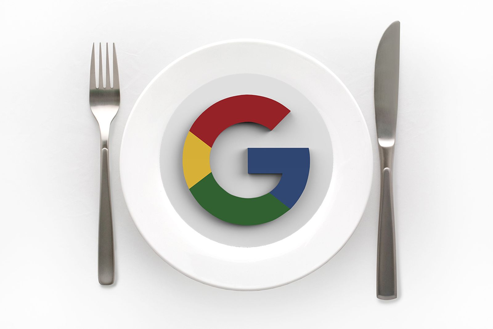 Google logo served on a white dinner plate between a fork and knife