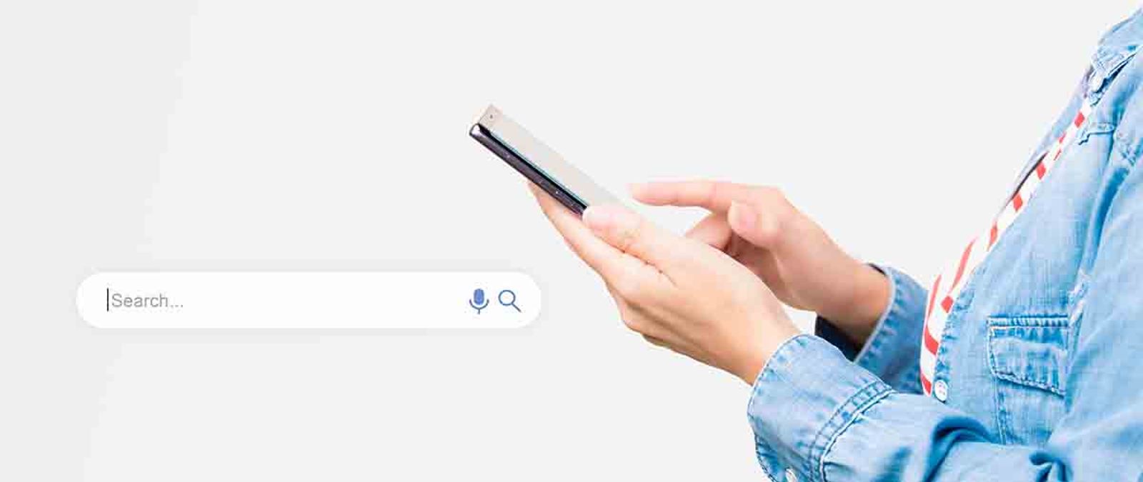 Person holding a smartphone beside a large search bar graphic with microphone and magnifier icons