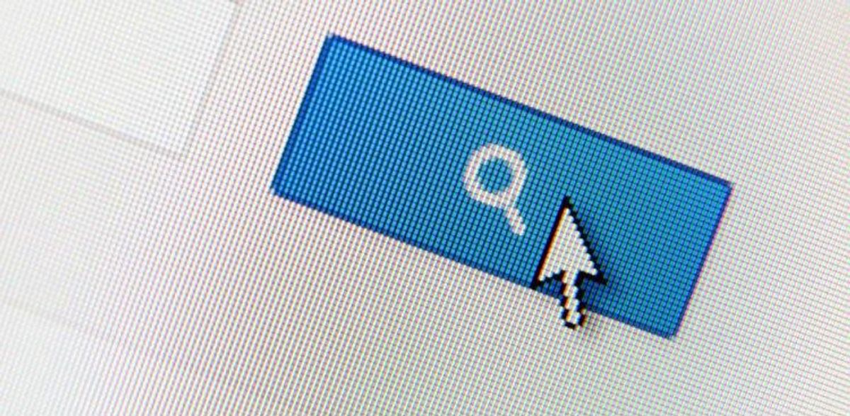 Pixelated blue search button on a screen with a cursor arrow hovering over it