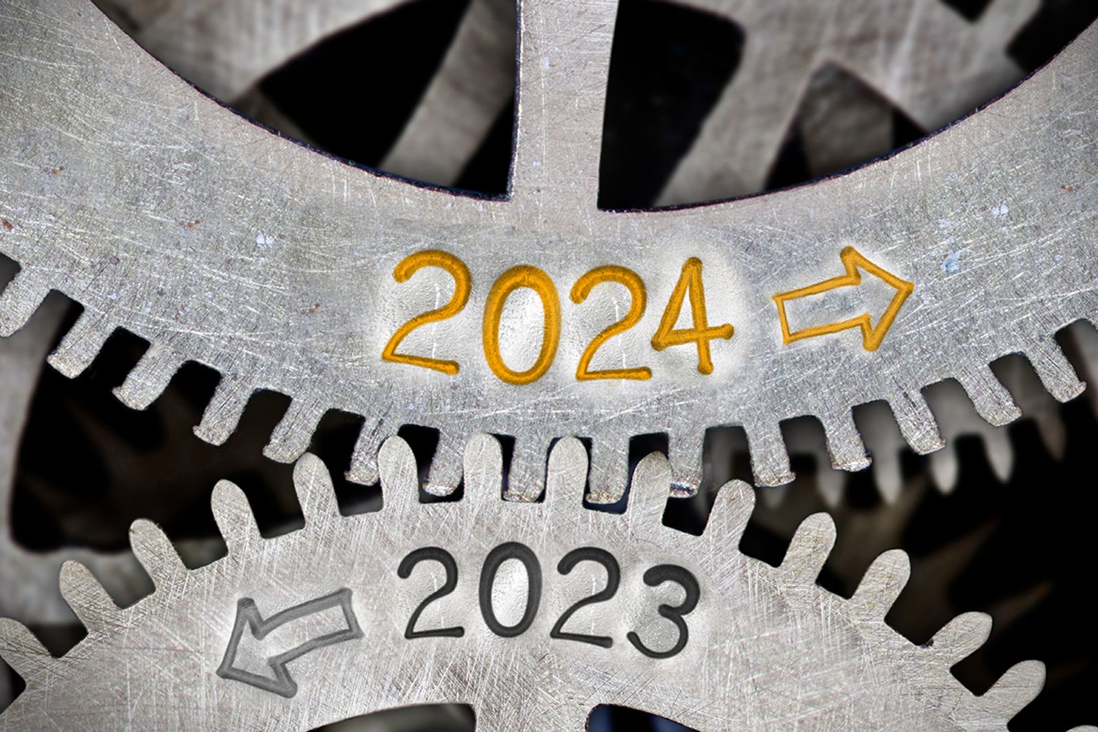 Metal gear teeth stamped with 2023 and 2024 and directional arrows in close-up