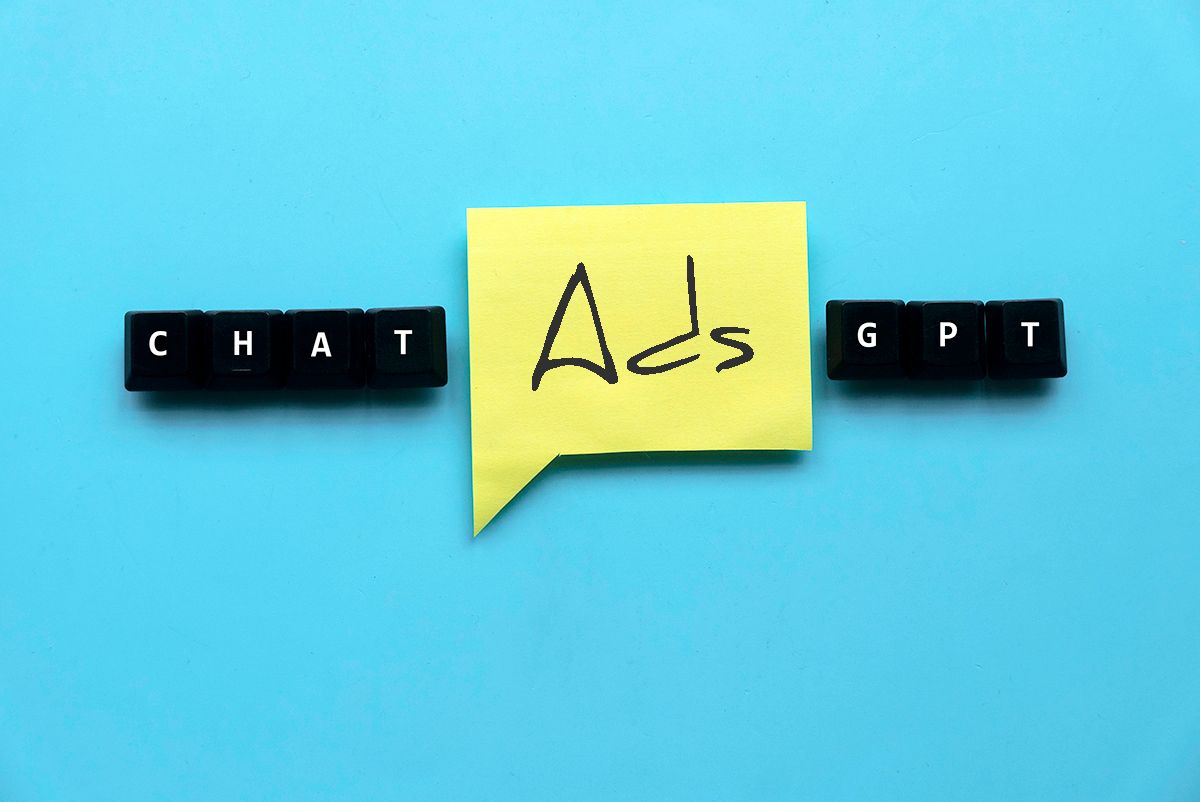 Keyboard keys spelling ChatGPT with a yellow sticky note reading Ads between them