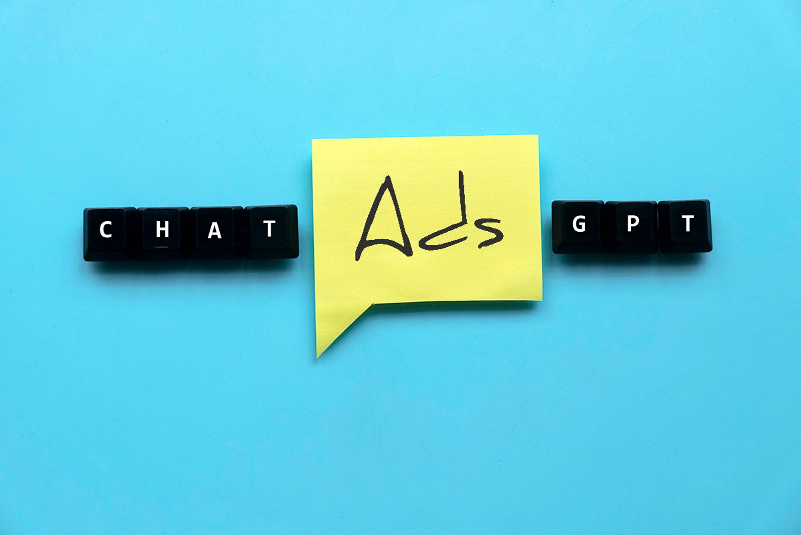 Keyboard keys spelling ChatGPT with a yellow sticky note reading Ads between them