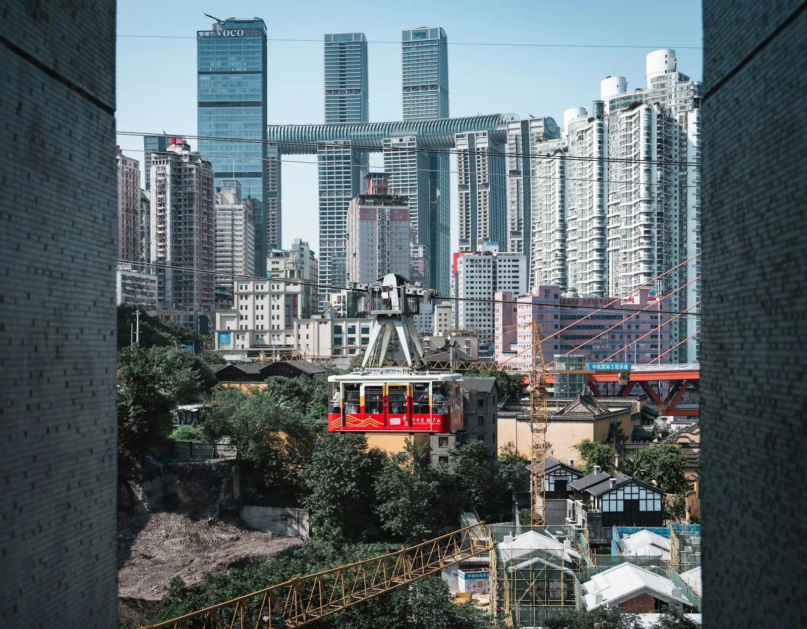 Kereta merah melintas di antara gedung tinggi Yuzhong, Chongqing