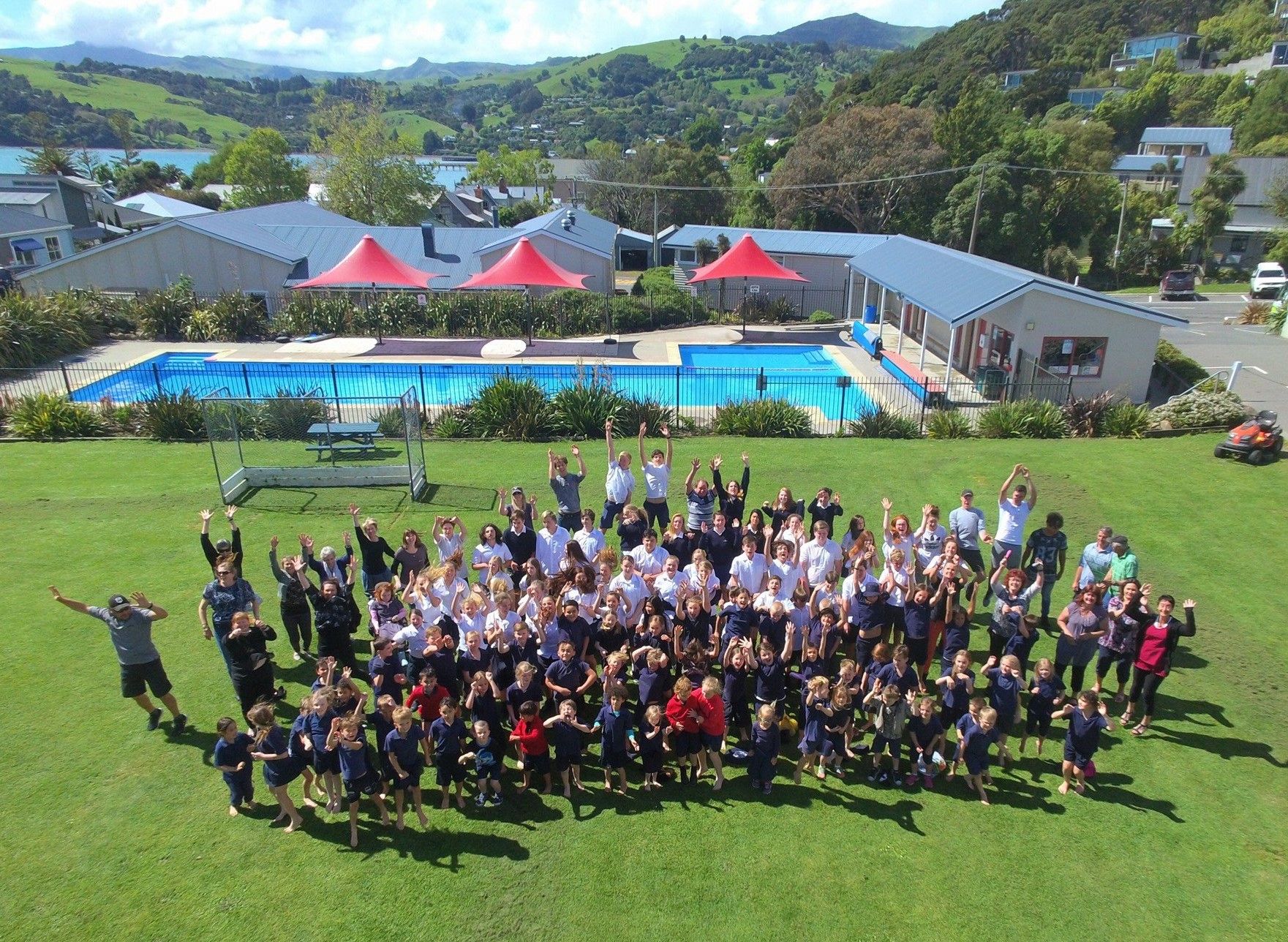 school grounds with pool and student group