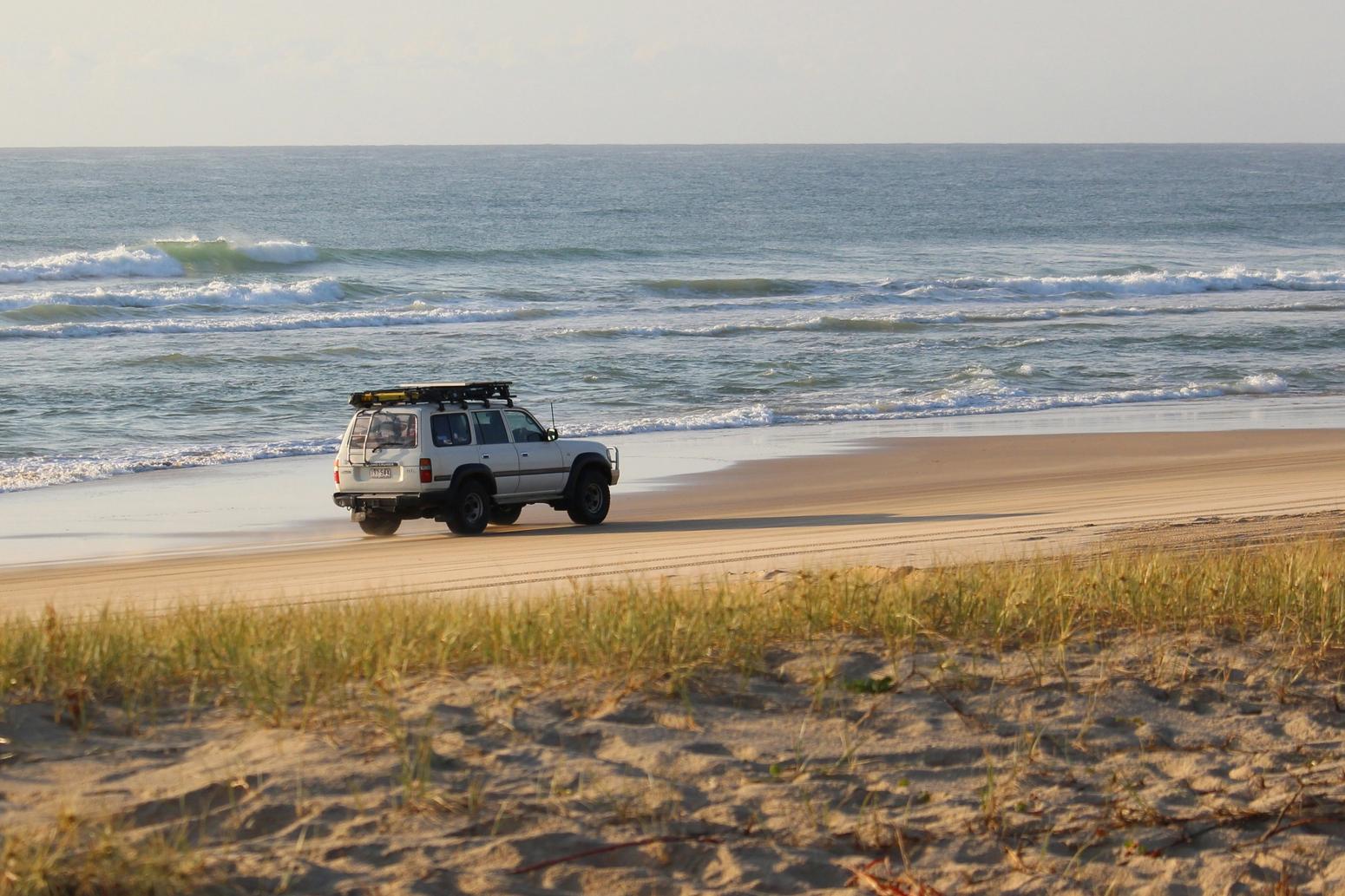 Ein Auto an einem breiten Strand