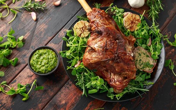 Cuisse d’agneau rôtie au romarin, ail et sauce à la menthe