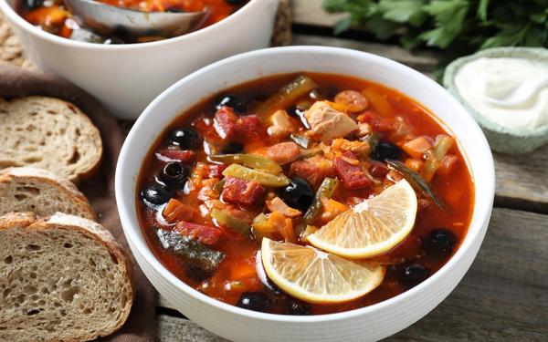 Soupe solyanka à la viande avec des saucisses, des olives et des légumes