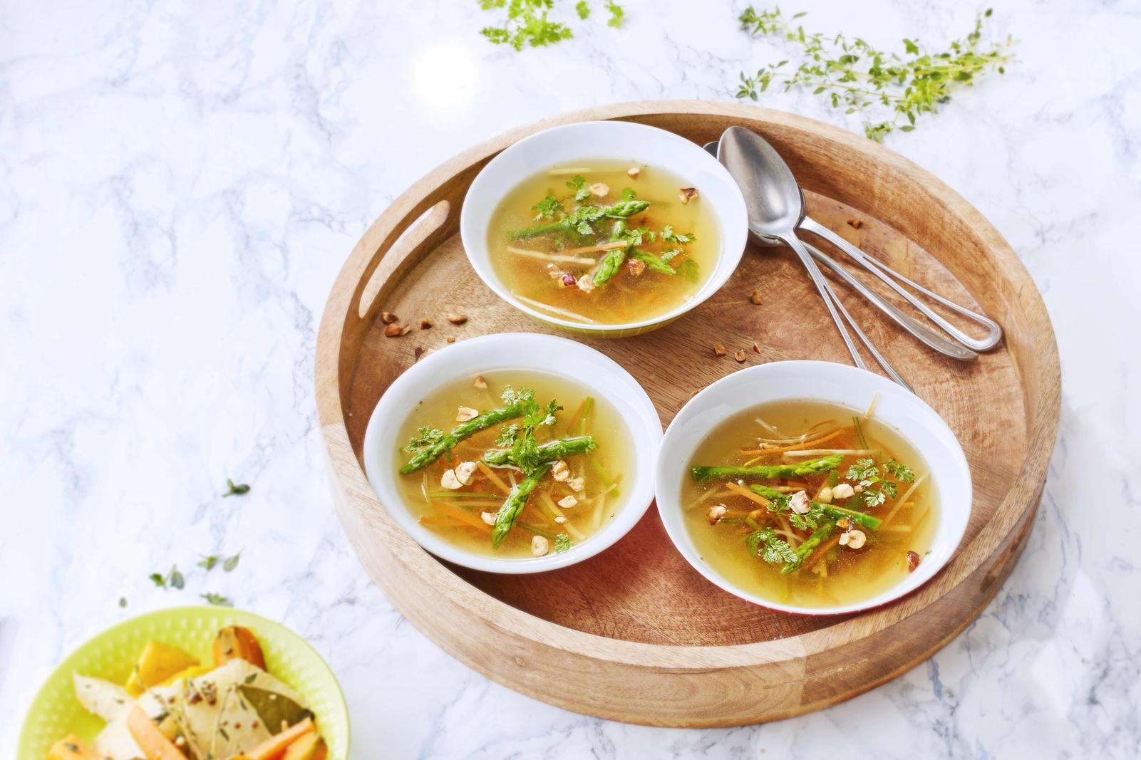 Consommé d'asperges, julienne de légumes, cerfeuil et noisettes