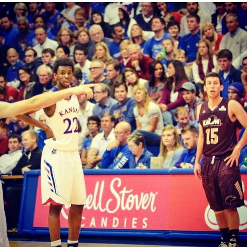 A Kansas player in the number 22 jersey points across court during a game against ULM.