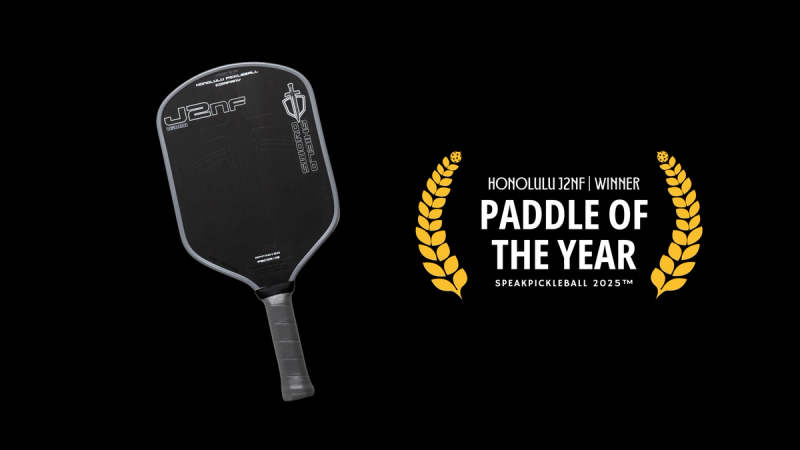 Honolulu J2NF paddle with an all-black face beside a gold laurel badge reading Paddle of the Year.