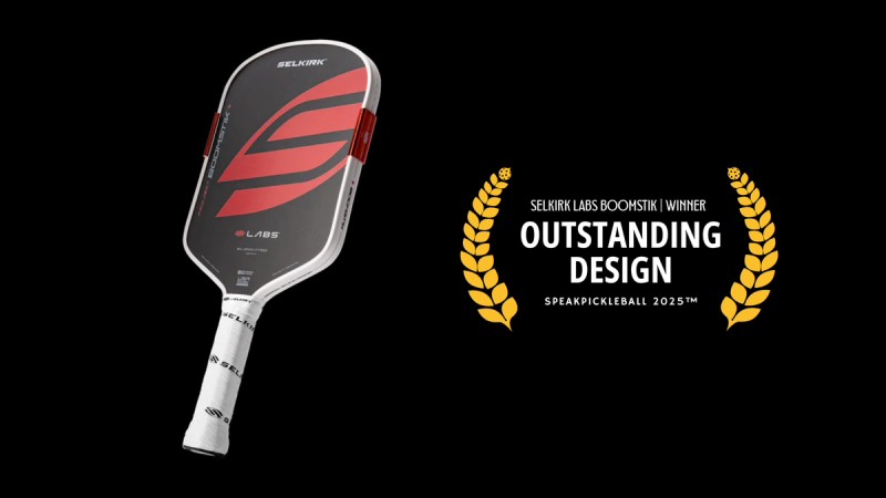 Selkirk Labs Boomstik paddle in red and black beside a gold laurel badge reading Outstanding Design.