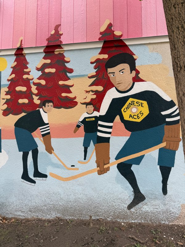 Public art mural in Ottawa's Glebe district celebrating Chinese-Canadian heritage and hockey history. The work depicts three players from the Chinese Aces team skating outdoors. Artist: Tia Wong.