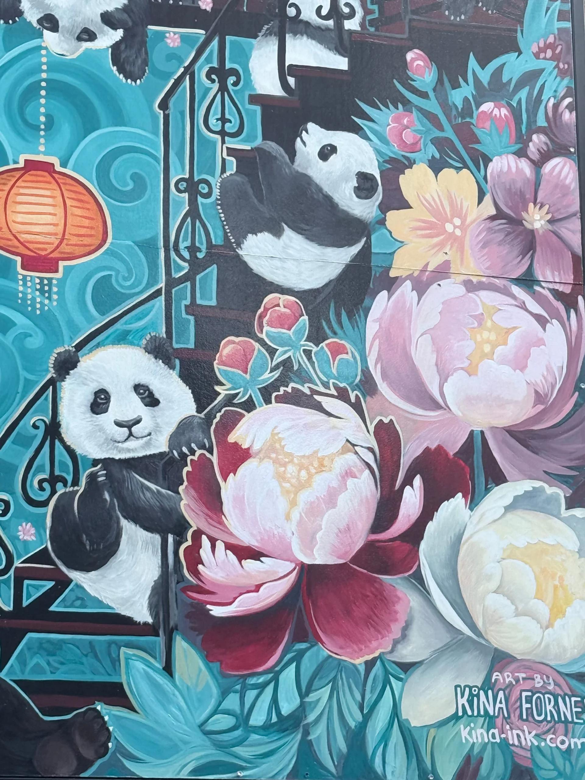 A colourful Kina Forney mural shows playful pandas on a staircase with a red lantern and pink peonies, in Chinatown, Ottawa.