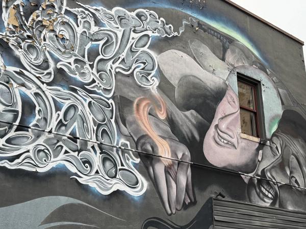 Urban Street Art Ottawa Gatineau: Mixed-media mural with a shouting conductor, Laporte's central graffiti script, and two massive faces in Lowertown. OTTAWALLS Mural Map.