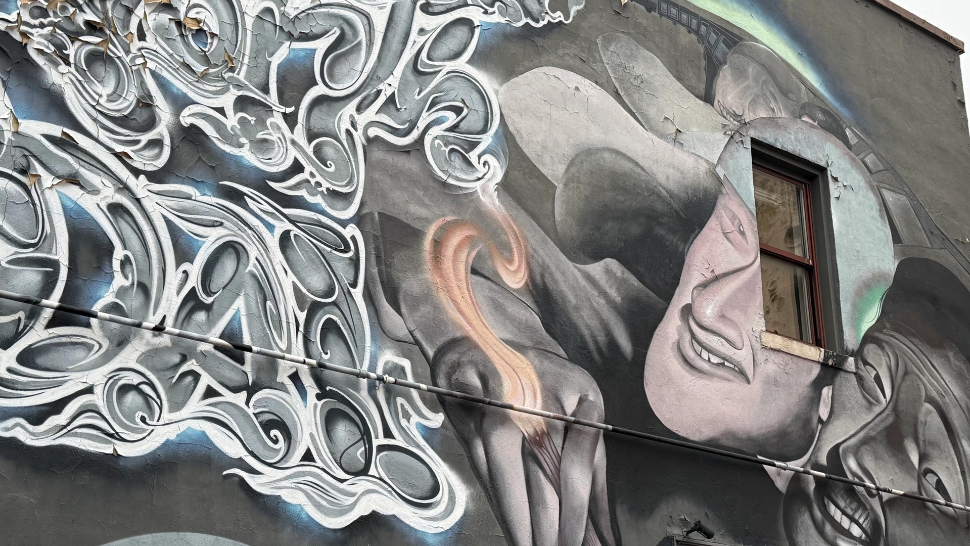 Urban Street Art Ottawa Gatineau: Mixed-media mural with a shouting conductor, Laporte's central graffiti script, and two massive faces in Lowertown. OTTAWALLS Mural Map.