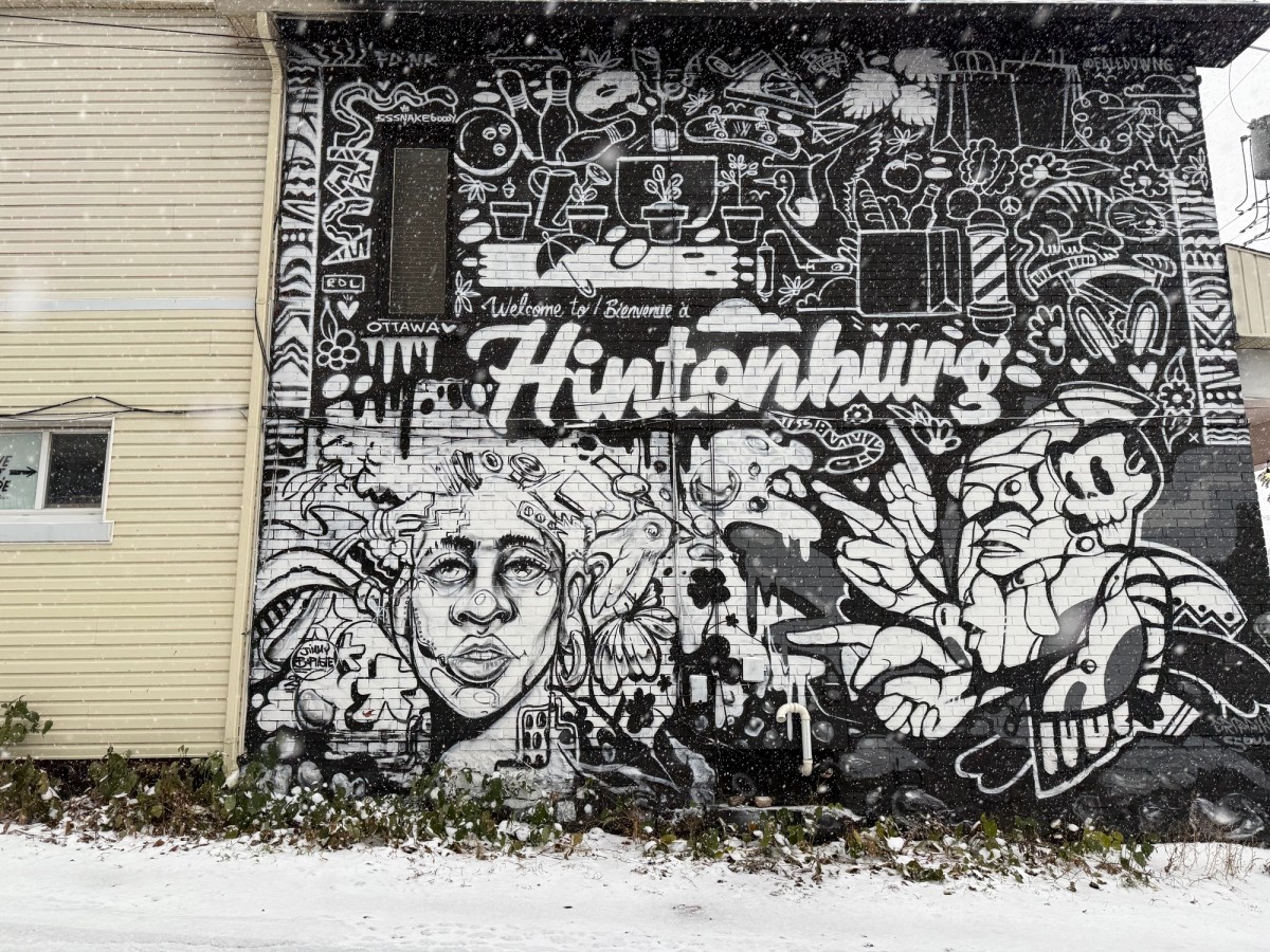 Welcome to Hintonburg mural by Jimmy Baptiste, showing stylized graphic novel style characters and a skull figure in black and white on a brick wall at Urban Art Collective on Somerset Street West, Hintonburg, Ottawa.
